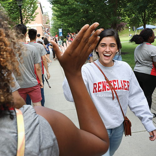 New student receives a high-five from the staff