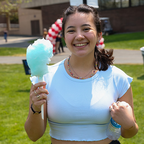 Student holds blue cotton candy