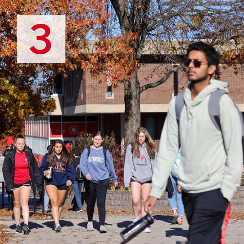 Number 3 overlayed over a picture of students walking on campus in the fall