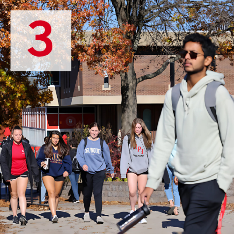 Students walk across campus on a beautiful Fall day